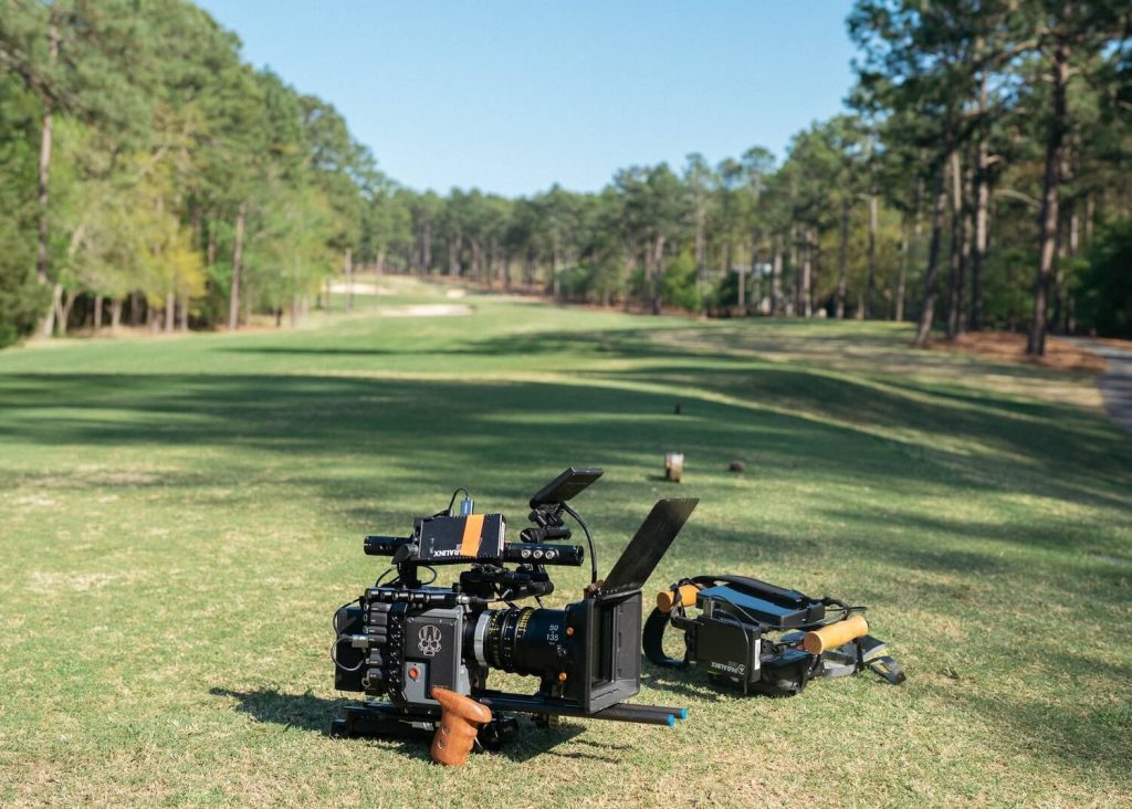 Camera equipment on the green grass of a golf course